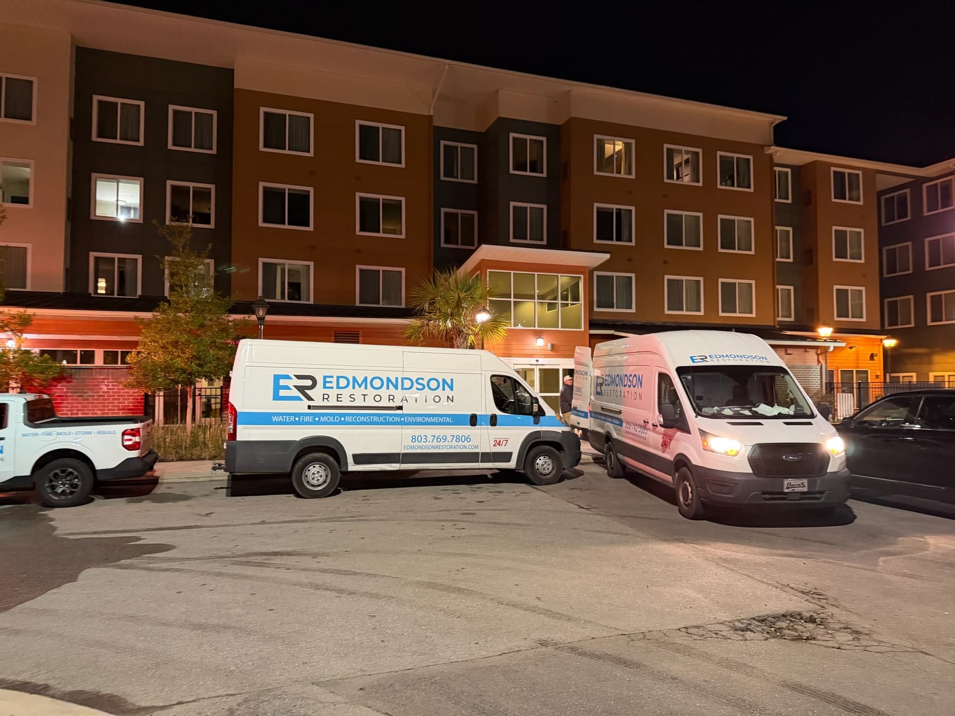 Edmondson Restoration commercial response trucks staged at a large facility
